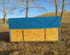 Green tarp over wood pile